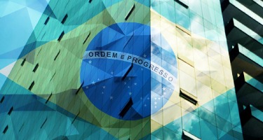 Brazilian Flag overlayed on brick building with triangle shape design squares on the image 