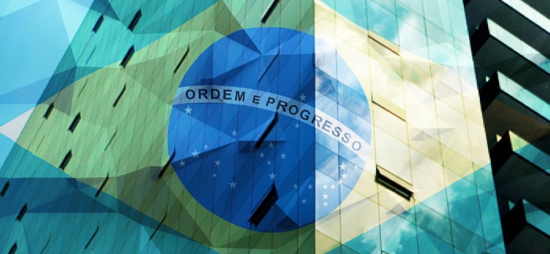 Brazilian Flag overlayed on brick building with triangle shape design squares on the image 