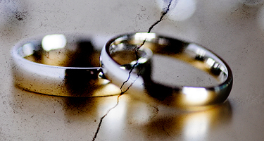 Two golden wedding bands with a crack down the middle