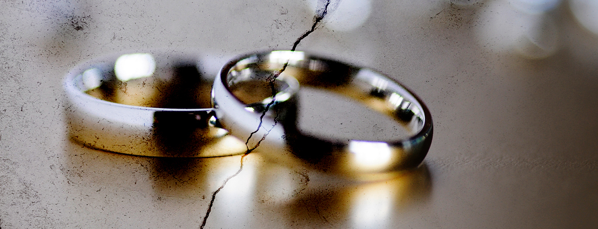 Two golden wedding rings with a crack down the middle