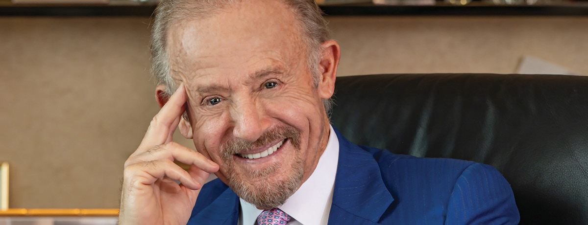 Lawyer smiles and poses for a picture in a blue suit