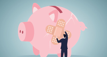 Large cracked piggy bank with person putting Band-aids on cracks