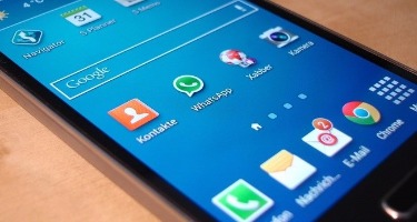 Unlocked Phone Screen with WhatsApp Pulled up on the home page 