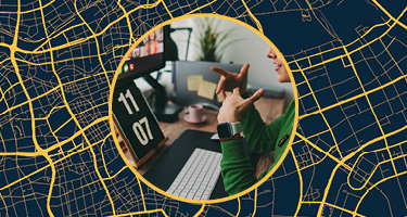 Woman at desk working with roadmap behind her