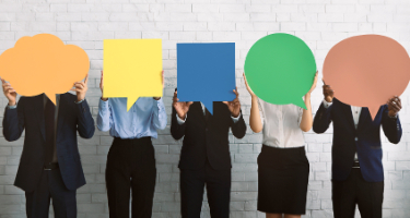 Group of professional lawyers holding colorful speech bubbles in front of their faces