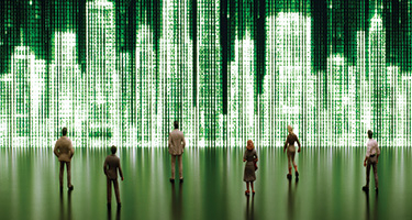People standing in front of large, green pixelated image of buildings