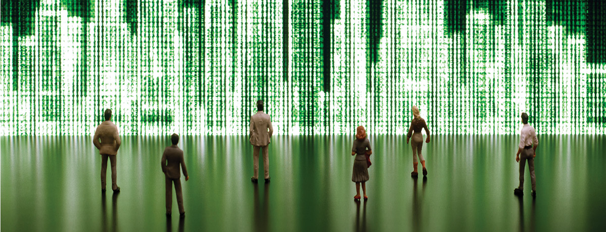 People standing in front of large, green pixelated image of buildings