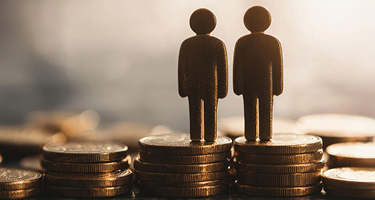 two figures standing on stacks of coins