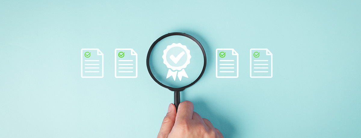 Magnifying glass over a ribbon icon, representing legal compliance