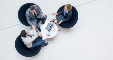Birds eye view of a lawyer sitting with clients