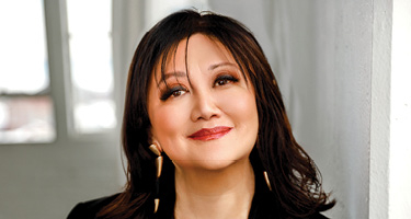  Athea Trial Lawyers headshot gold jewlery black top 