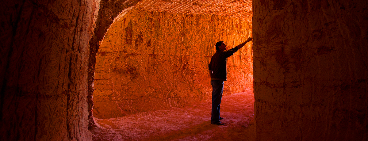 Man pointing to cave wall