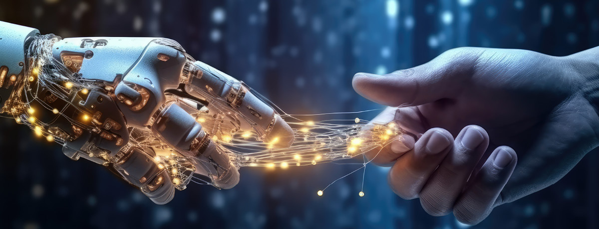 Robotic hand about to touch human hand connected by wires