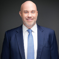 Headshot of man in blue suit