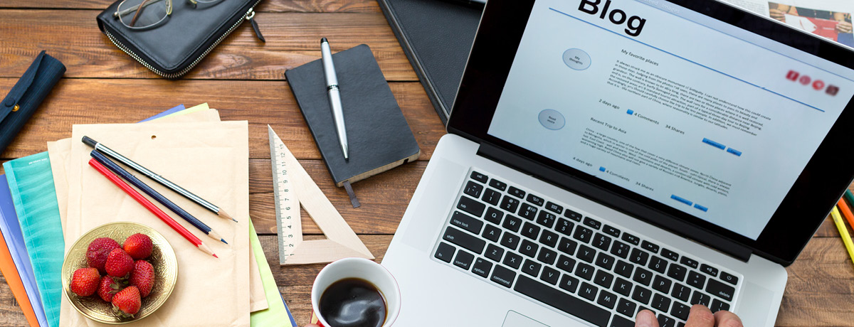 Lawyer typing blog content on laptop in office