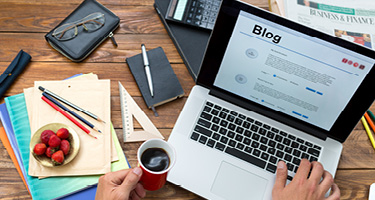 Lawyer typing blog content on laptop in office