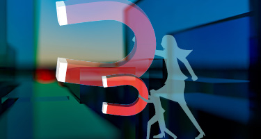Two silhouettes holding different size magnets