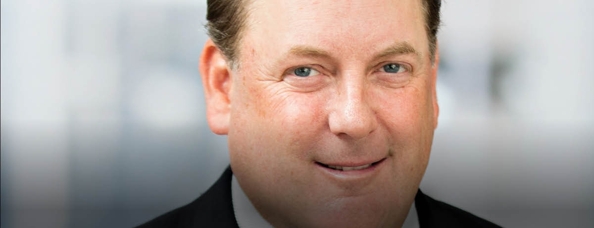 Suited man poses for professional headshot