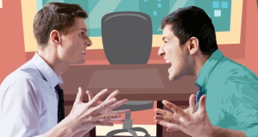 Two male business partners arguing across a desk 