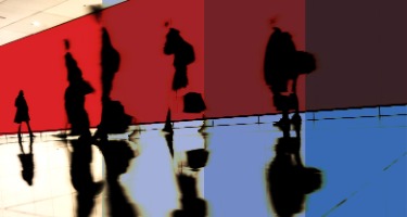 Red and white stripes on the side of a building with black dots on the building