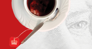 Teacup on saucer over image of Queen's eye