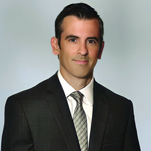 Suited man standing in front of white background