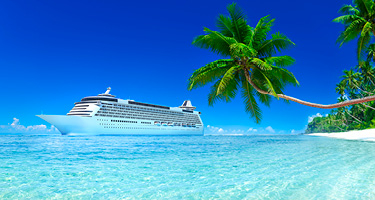 Cruise ship in the blue ocean in the Bahamas with palm trees