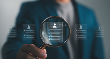 Figure holding magnify glass over digital profile