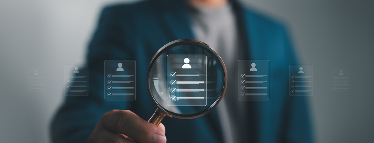Figure holding magnify glass over digital profile