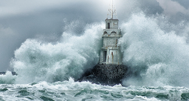 Waves crashing into lighthouse