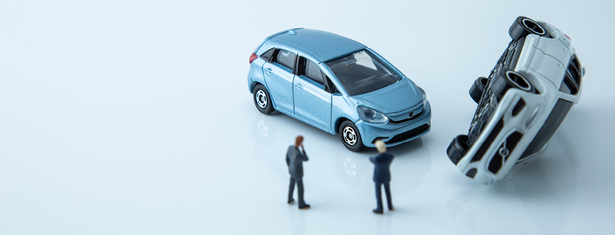 Two Two People Standing Near a Toy Car Accident