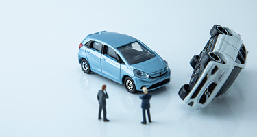 Two Two People Standing Near a Toy Car Accident