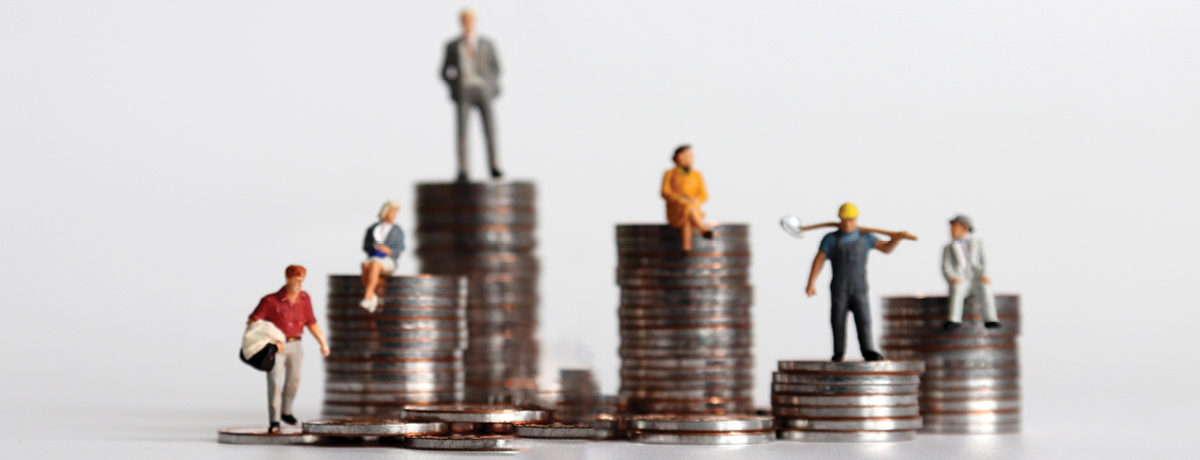Small figurines stand on stacks of coins