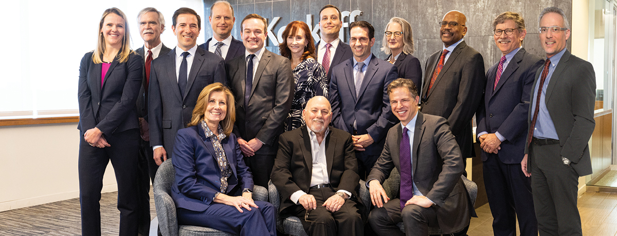 Group of suited lawyers gather for a picture
