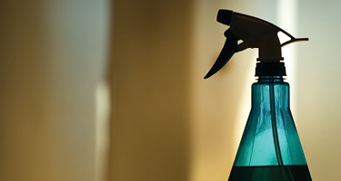 Shadowy backlit blue liquid spray bottle 