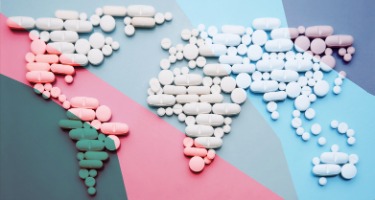 Pharmaceutical pills scaled nationwide with pills aligned in a map of the world