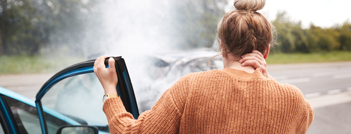 Woman Getting Out of the Passenger Side of a Damaged Car