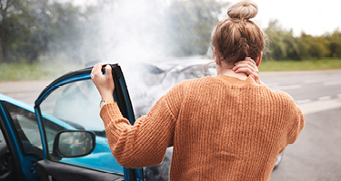 Woman Getting Out of the Passenger Side of a Damaged Car