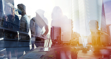 Shadows of people on a busy street and office buildings
