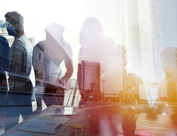 Shadows of people on a busy street and office buildings