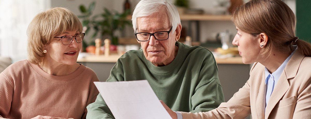 Older couple reviewing document with young woman