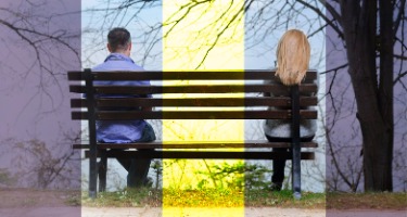 Spouses sit separate from each other on a bench the beginning of divorce