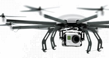 Black drone with white camera attached 