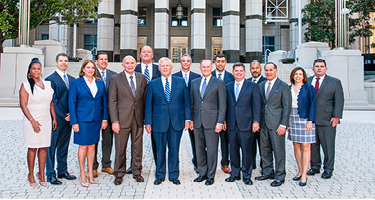 Group of lawyers standing together outside in front of building