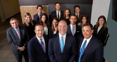 Attorneys of Dussias Wittenberg Koenigsberger LLP Smile for a Group Photo