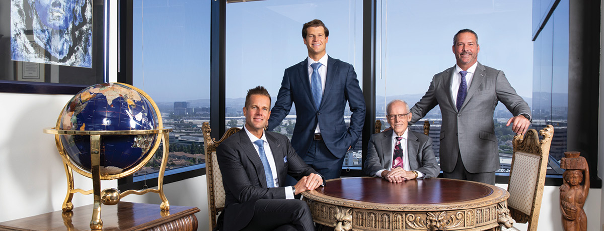Group of lawyers pose at table with globe in forefront