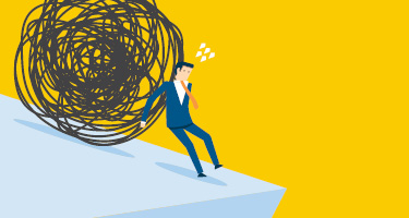 Man holding a large ball to prevent it from rolling downhill