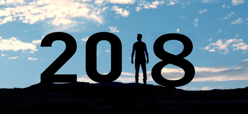 Man stands in the one in 2018 as a silhouette with a blue sky with white clouds 