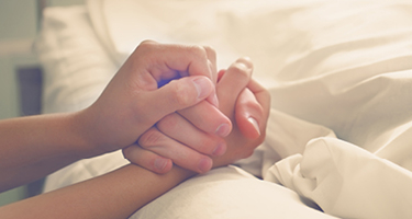 Unseen figures holding hands