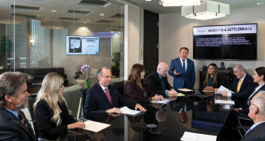 Lawyers sitting around a table in conference room